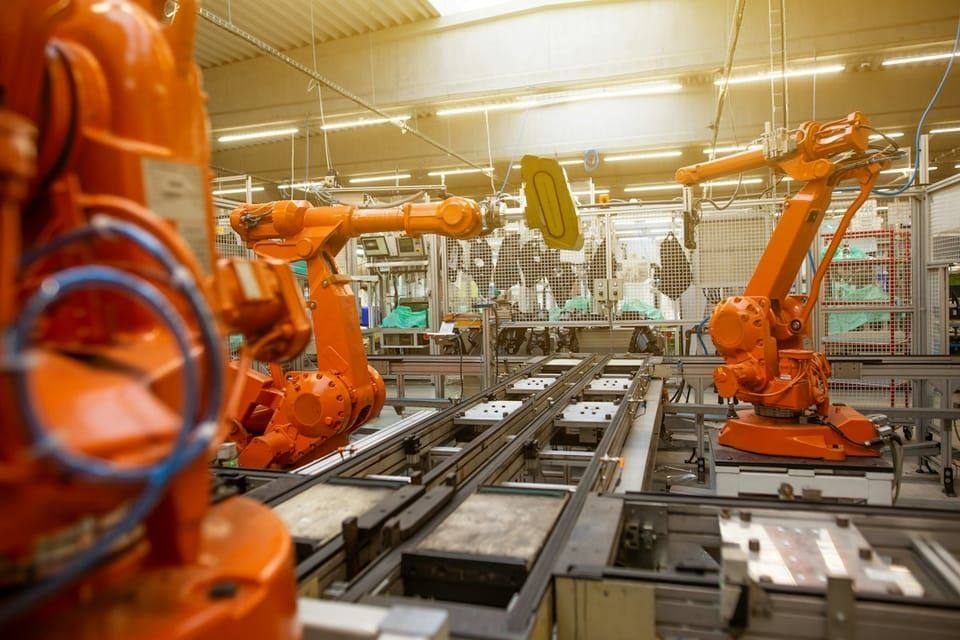 Robotic arms on an automotive assembly line